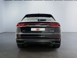 the rear end of an audi v7 sedan parked in a showroom