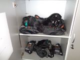 many bags of luggage sitting on a shelf in a closet