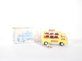 a yellow toy bus with a fork in front of it