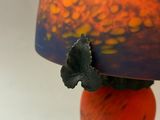 a vase with a flower on top of it