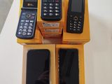 several cell phones sitting on top of a yellow box on a table