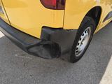 a close up of a yellow truck parked in a parking lot