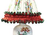 a lamp that has a red and white shade on it