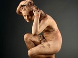 une image représentant la statue d'un homme assis sur une table