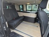 the interior of a van with the door open and a bench in the back