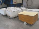 many bins that are sitting on the floor in a room