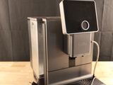 the coffee machine is sitting on the table ready to be used