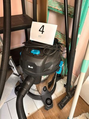 a vacuum that is sitting on the floor next to a chair