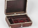 a brown case with four compartments on a white surface