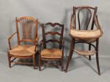 three wooden chairs and a chair with a cushion on top of them