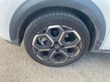 the tire of a car with a flat tire on the side of the road