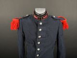 a blue military jacket with red fringes on the shoulders