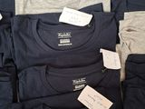 a lot of t - shirts that are on a table