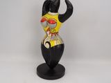 a figurine of a cat that is on a stand