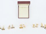 five pairs of cufflinks and a ring in a box