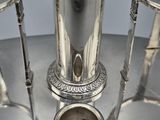 a silver plate with a silver tea pot on it