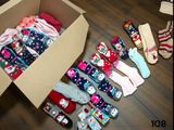 many pairs of socks in a box on the floor