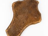 an old, worn leather shield on a white background
