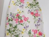 a white dress with a floral pattern on it on a table