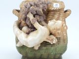 a ceramic vase with a dog and a basket full of animals