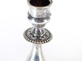 a silver candle that is sitting on a table