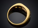 a close up of a gold ring on a black surface