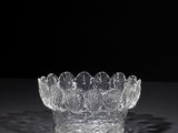 crystal bowl on a black surface with a black background