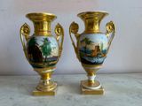 two vases that are sitting on a table