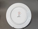 a white plate with a picture on it sitting on a table