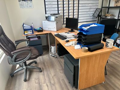 a desk with a chair and a computer on it