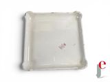 a small white plate with a red design on it