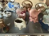 a shelf with many different types of vases and figurines on it