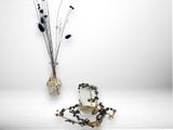a vase with a bunch of flowers in it next to a vase with beads