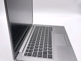 a silver laptop computer sitting on top of a white table