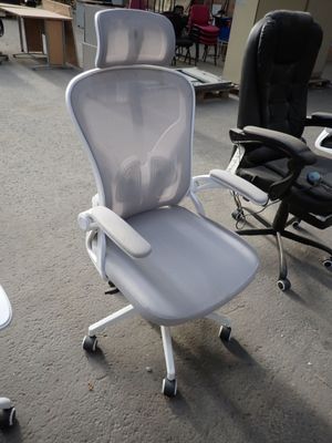 a white office chair that is sitting in the middle of a room