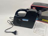 a black and white photo of an electric hand held vacuum