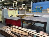 several pieces of wood are stacked on a table in a warehouse