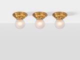 a pair of gold earrings with diamonds on a white surface