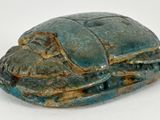 an image of a blue and green stone statue of a bug