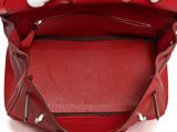 the inside of a red handbag with a zipper on the inside