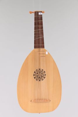 an old, wooden instrument with a wooden body and strings