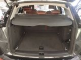 the back of a car with the trunk open and the seats folded down