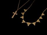 three gold necklaces with crosses and a cross on them