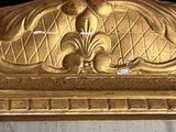a gold frame with a picture of a bird on it