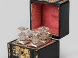 a small black box with a gold decoration on it