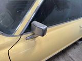 a yellow car that is parked on the side of the street