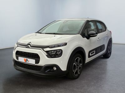 a white citrole is parked in a large room