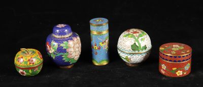 several different colored vases are lined up on a black surface