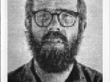 an old black and white photo of a man with glasses and a beard