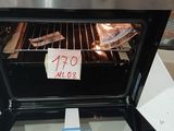 a sign on the door of an oven that is open